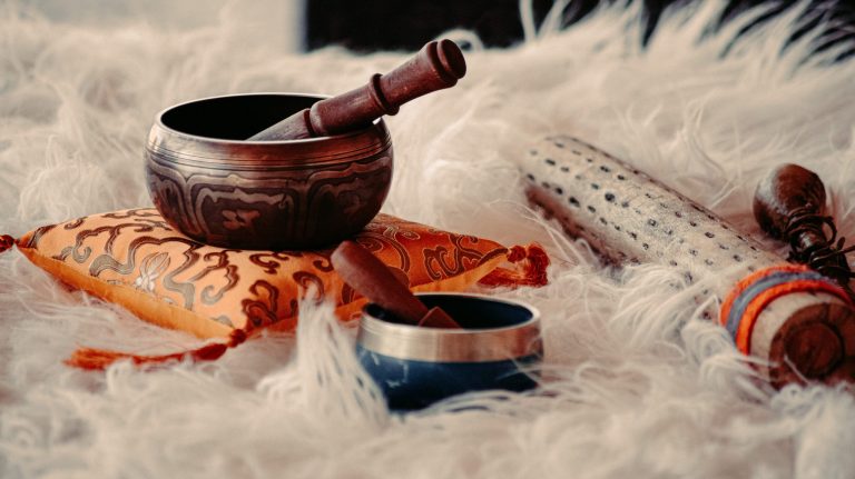 Tibetan singing bowls resting on a sheepskin rug