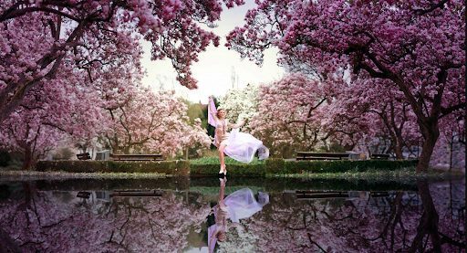 Woman running through Japanese cherry blossom trees
